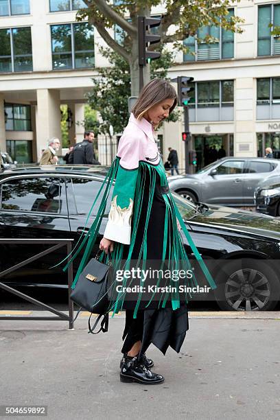 Fashion editor for Vogue Ukraine Julie Pelipas wears a Marianna Senchina jacket, Balenciaga boots and a Zac Posen bag on day 9 during Paris Fashion...