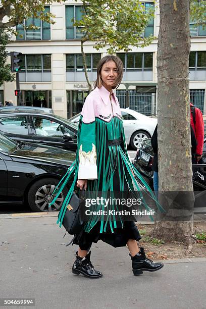 Fashion editor for Vogue Ukraine Julie Pelipas wears a Marianna Senchina jacket, Balenciaga boots and a Zac Posen bag on day 9 during Paris Fashion...