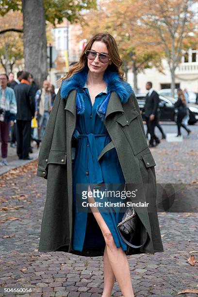 Fashion stylist and writer Ece Sukan wears a Mr and Mrs Italy trench coat, Tod's bag, Gucci shoes, umitbenan plus one dress on day 9 during Paris...
