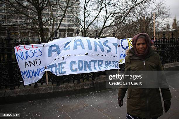 Woman walks past a banner erected during a picket outside St Thomas' Hospital on January 12, 2016 in London, United Kingdom. Junior doctors in...