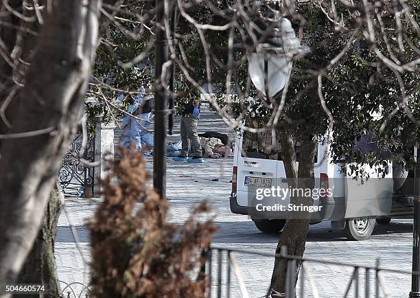 Dead body lies on the ground as police secure the area after an explosion in the central Istanbul Sultanahmet district on January 12, 2016 in...