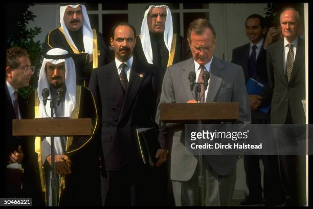 Pres. Bush & Kuwaiti Emir Jaber al-Ahmad Al Sabah , at twin podiums, w. Interpreter & NSC 's Scowcroft , at WH portico ceremony.