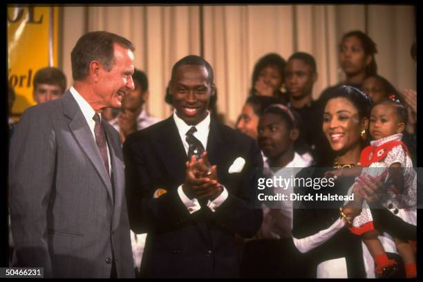 Pres. Bush w. Track star Flo Jo Griffith Joyner, husband Al Joyner & baby Mary, paying call at Alice Deal Jr. HS.