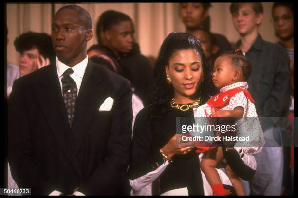 Track star couple Al Joyner & Flo Jo Griffith Joyner, w. Baby Mary in her arms, paying call at Alice Deal Jr. HS.