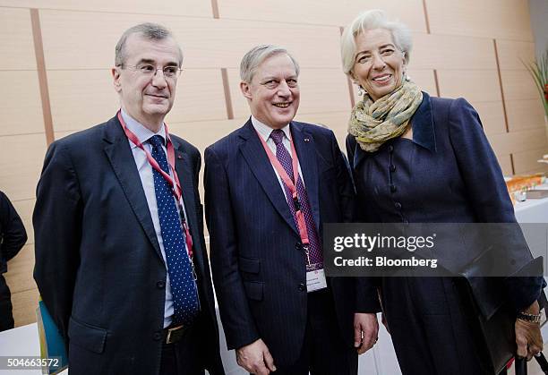 Francois Villeroy de Galhau, governor of the Bank of France, left, poses for a photograph with Christian Noyer, former governor of the Bank of...