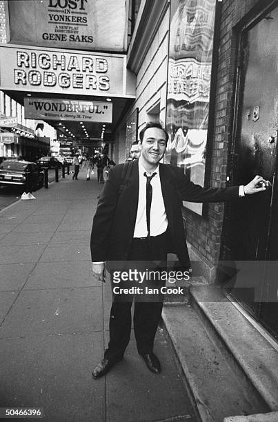 Actor Kevin Spacey posing at stage door of w. Marquee in bkgrd. At the Richard Rodgers Theater where he is performing in the play Lost in Yonkers.