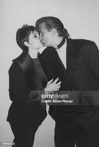Ponytailed actor Steven Seagal smooching wife/actress Kelly LeBrock at party celebrating his film Out For Justice.