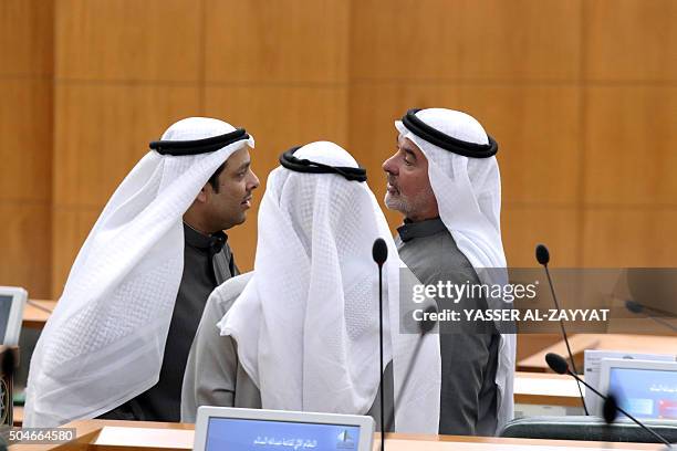 Kuwaiti Minister of Justice and of Awqaf and Islamic affairs Yaqoub al-Sanea speaks with Kuwaiti Shiite MP Saleh Ashour during a parliament session...