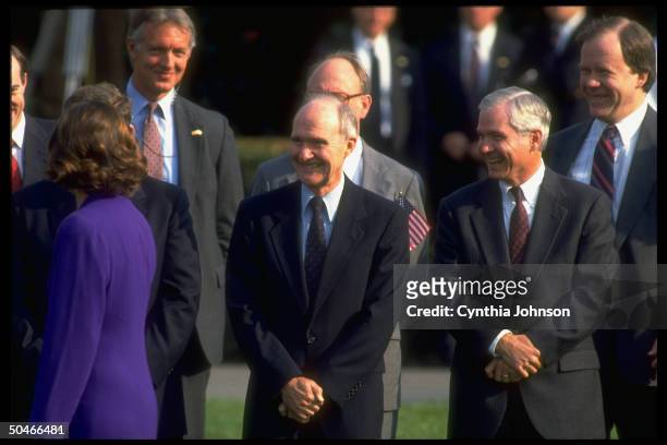 Adviser Brent Scowcroft smiling it up w. His dep. Bob Gates & other WH men, appearing to be enjoying view of passing woman in body-hugging dress.