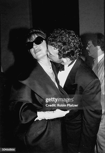 Actress Maureen Garrett w. Dark sunglasses being nibbled by her boyfriend David Birshins during 18th Annual Daytime Emmy Awards.