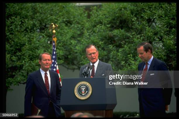 Pres. Bush speaking, flank- ed by Education Secy. Lamar Alexander & NJ Gov. Tom Kean, in WH Rose Garden.