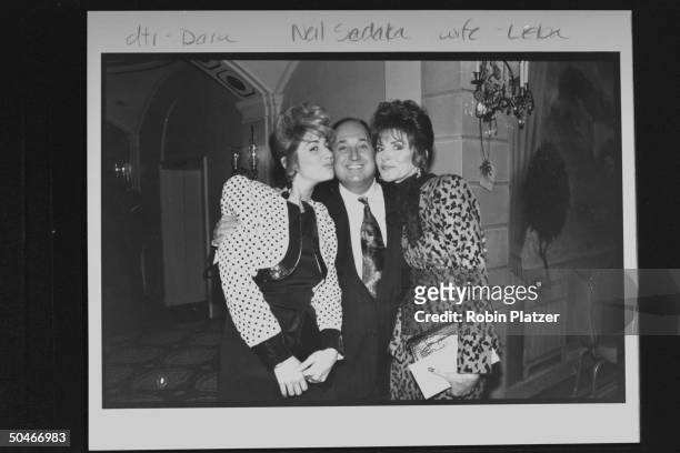 Singer Neil Sedaka posing cheek to cheek w. His wife Leba & daughter Dara at the premiere party for the newly restored version of the movie Spartacus.