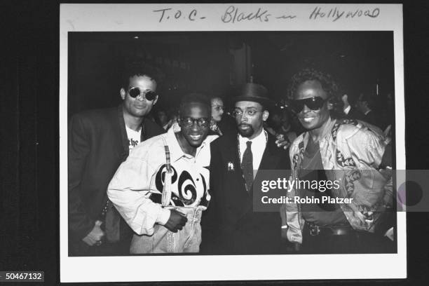 Movie dir. Spike Lee posing w. Jazz great Miles Davis & movie directors Mario Van Peebles & Matty Rich at premiere of his movie Jungle Fever.