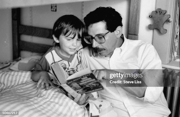 Phil Zuckerman, publisher for Applewood Books, reading an original THE HARDY BOYS mystery book to his young son Andy; this mystery series was...