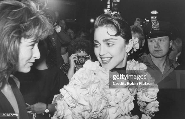 Actress Jennifer Grey chatting w. Singer Madonna at Tony Awards party at Sardi's restaurant.