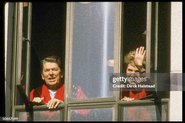 Pres. & Nancy Reagan at window of Bethesda Naval Hospital, Pres. Looking fit as fiddle, in good spirits, undergoing prostate surgery.