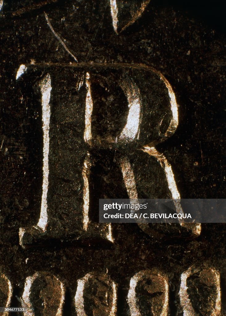 Letter R In Roman Detail of the letter R, symbol of the Rome mint, on the flip side of ...