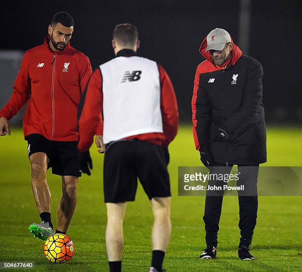 Jurgen Klopp manager of Liverpool talks with Steven Caulker and Brad Smith during a training session at Melwood Training Ground on January 12, 2016...