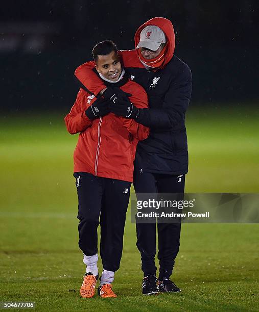 Jurgen Klopp manager of Liverpool talks with Allan Rodrigues de Souza during a training session at Melwood Training Ground on January 12, 2016 in...