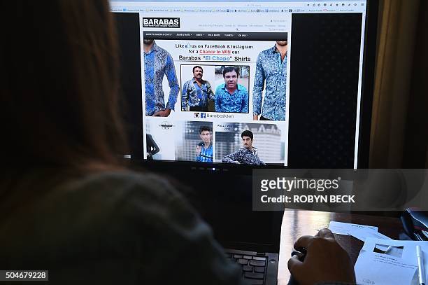 Woman looks at the homepage of the clothing house Barabas which features a photo of Mexican drug lord Joaquín Guzmán Loera "El Chapo", January 12,...