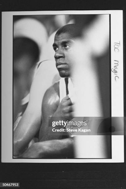 Lakers' star Magic Johnson sitting on bench during NBA championship basketball game between the Bulls & the L.A. Lakers at Chicago Stadium.