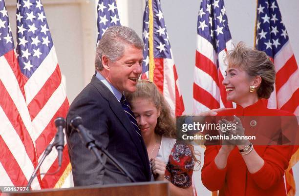 Arkasas Governor Bill Clinton celebrating w. Wife Hillary & daughter Chelsea at press conference announcing his candidacy for president of the United...