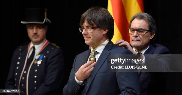 Outgoing President of the Catalan Government and leader of the Catalan Democratic Convergence Artur Mas puts a medal around the neck of new elected...