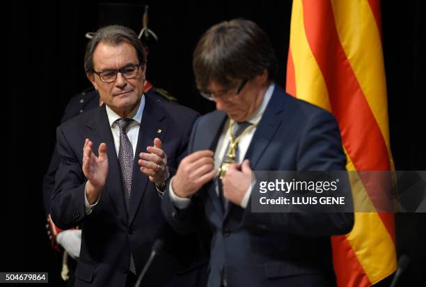 Outgoing President of the Catalan Government and leader of the Catalan Democratic Convergence Artur Mas applauds new elected President of the Catalan...