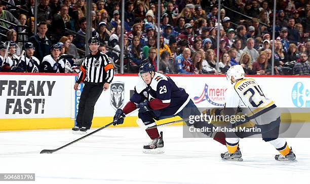 Nathan MacKinnon of the Colorado Avalanche skates Eric Nystrom of the Nashville Predators at the Pepsi Center on January 8, 2016 in Denver, Colorado....