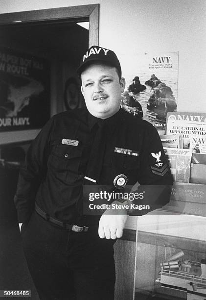 Petty officer Tom Perry, a Navy recruiter who is the older brother of actor Luke Perry, posing in his uniform at recruitment center office.
