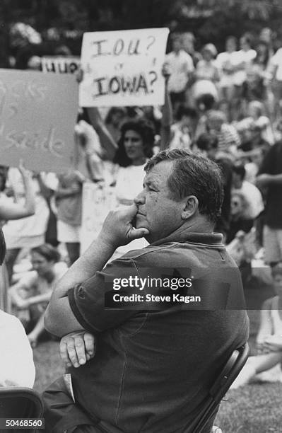 Ex-actor/self-proclaimed pres. Cand. Tom Laughlin patiently sitting in folding chair as he waits his turn to speak at a rally of students protesting...