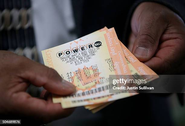 Customer holds Powerball tickets that he purchased at Kavanagh Liquors on January 12, 2015 in San Lorenzo, California. Dozens of people lined up...