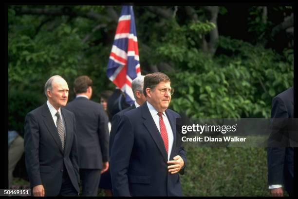 Chief of Staff John Sununu w. NSC's Brent Scowcroft in tow, framed by Union Jack-flying WH grounds during arrival fete for British royals.