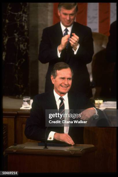 Pres. Bush taking applause while addressing Joint Session of Congress, framed by Sen. Pres. VP Dan Quayle & flag backdrop.