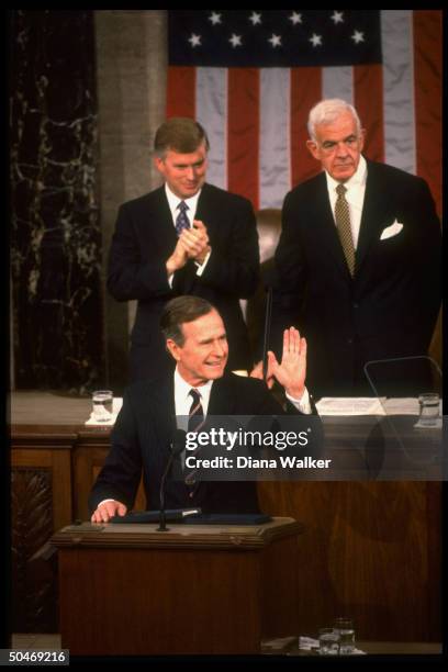 Pres. Bush acknowledging fans while addressing Joint Session of Congress, framed by House Spkr. Tom Foley , Sen. Pres. VP Dan Quayle & flag backdrop.