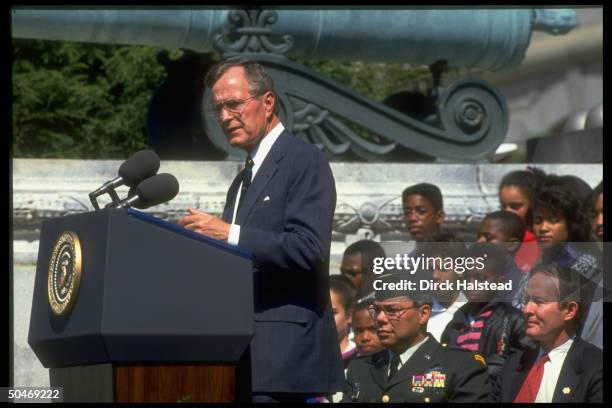 Pres. Bush addressing Naval Academy Points of Light fete, framed by audience incl. Gen. Powell & Education Secy. Alexander .