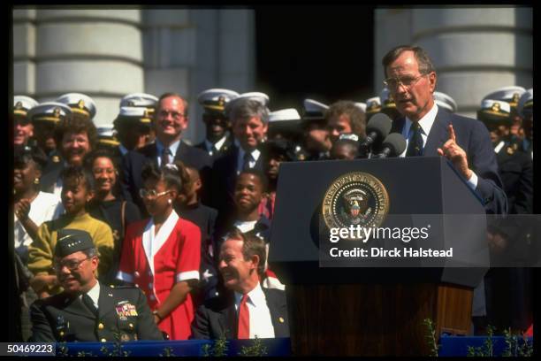 Pres. Bush addressing Naval Academy Points of Light fete, framed by audience incl. Gen. Powell & Education Secy. Alexander .