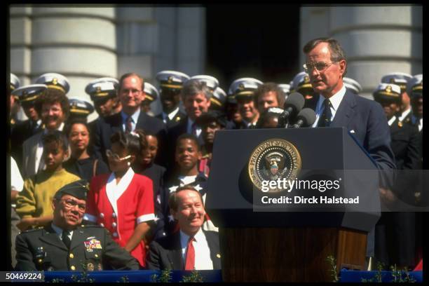 Pres. Bush addressing Naval Academy Points of Light fete, framed by audience incl. Gen. Powell & Education Secy. Alexander .