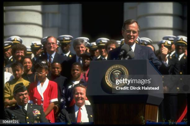 Pres. Bush addressing Naval Academy Points of Light fete, framed by audience incl. Gen. Powell & Education Secy. Alexander .