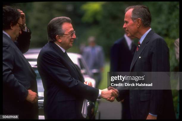 Pres. Bush shaking hands w. Italian PM Andreotti, w. For. Min. De Michelis , arriving for G7 summit.