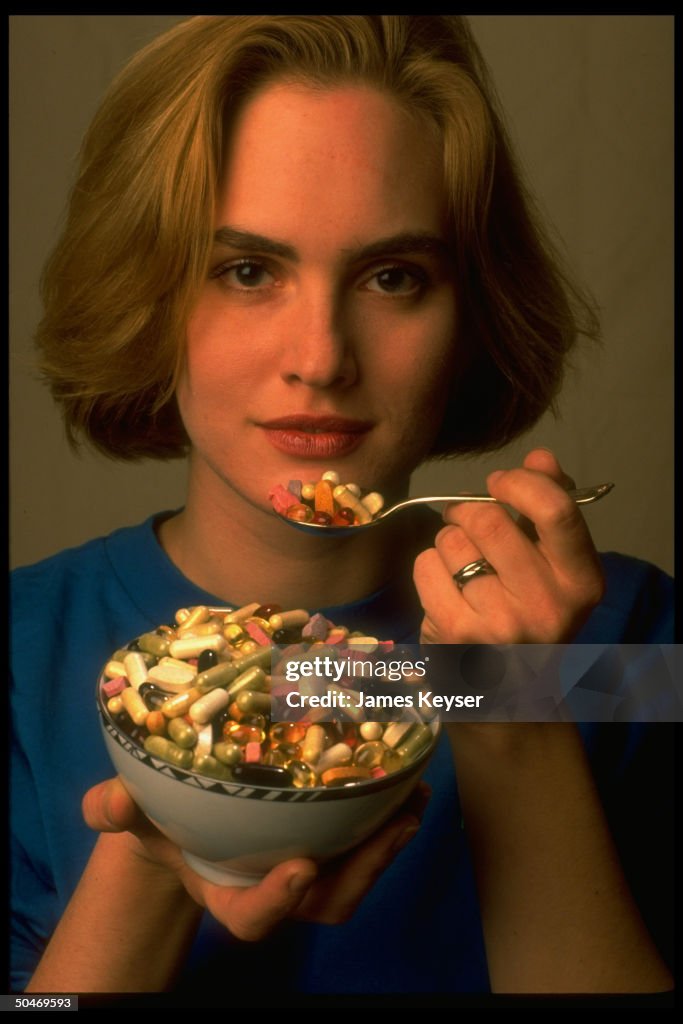 Young woman lifting loaded spoon to her