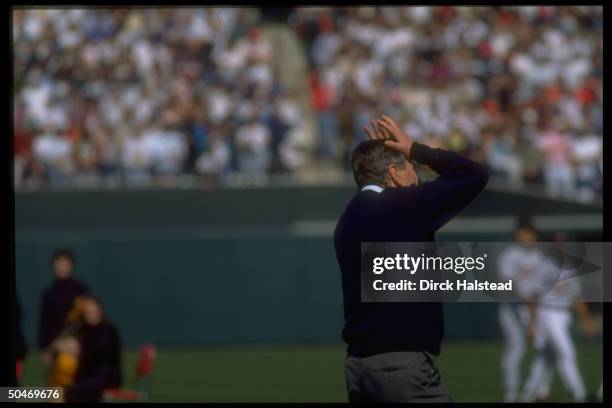 Pres. Bush emoting, bemoaning his errant pitch, opening Orioles baseball season debut game at team's new stadium, Oriole Park Yards, Baltimore, MD.