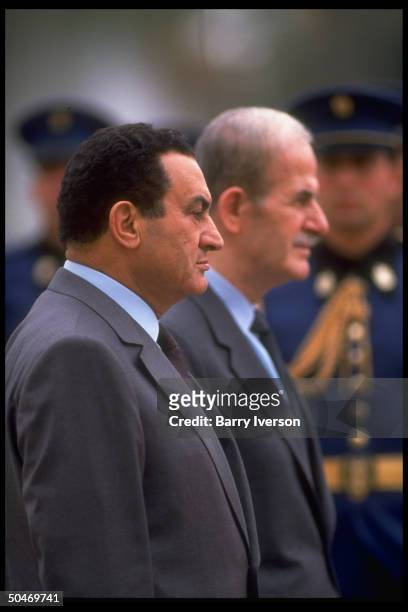 Syrian Pres. Hafez Al Assad w. His host Pres. Hosni Mubarak during arrival fete honor guard review.