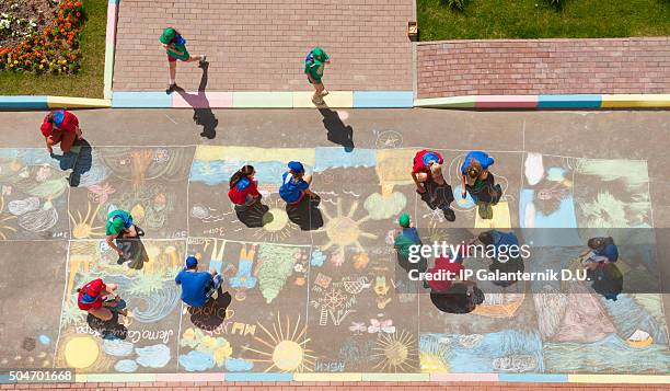 overhead view of children drawing chalk pictures - drawing art product 個照片及圖片檔