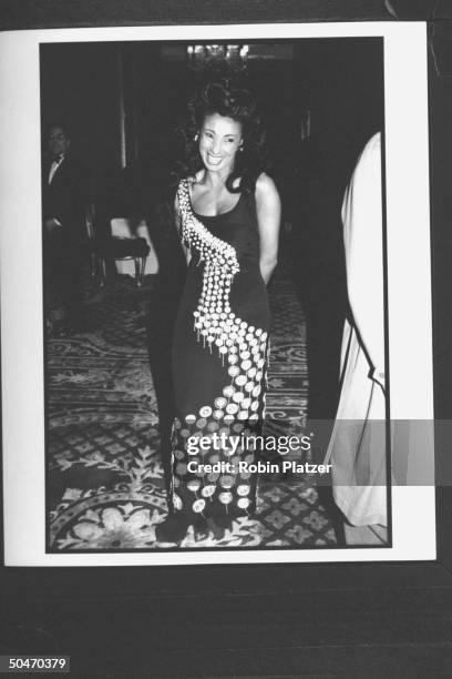 Writer, actress, singer Julie Brown in long sleeveless gown w. A flowing design of metallic circles which cascade from her right shoulder down across...
