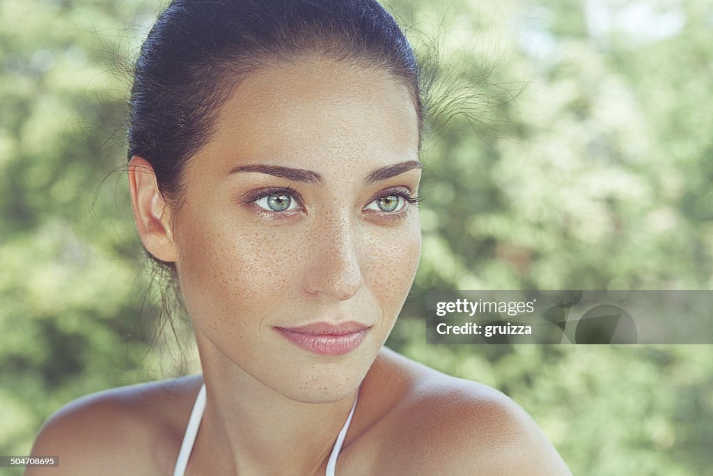 Outdoor, close-up, beauty portrait of a beautiful freckled woman