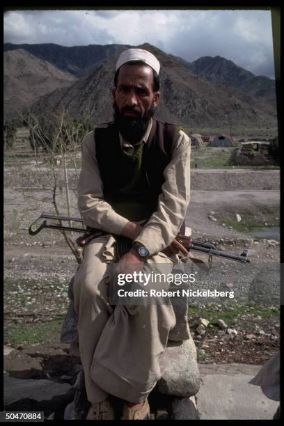 Ethnic Pathan mujahedin fighter poised w. Rifle-on-lap , based in Salafiya rebel faction-controlled Kunar province.