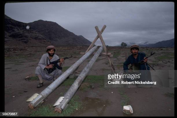 Pathan mujahedin w. Wooden launcher-propped Sakur 20 rockets , in Salafiya-controlled Kunar valley nr. Asadabad, Afghanistan.