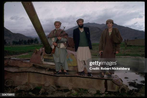 Ethnic Pathan mujahedin based in Salafiya rebel-controlled Kunar province, poised atop old Afghan tank fr. King Zahir Shah period.IN/NR Asadabad