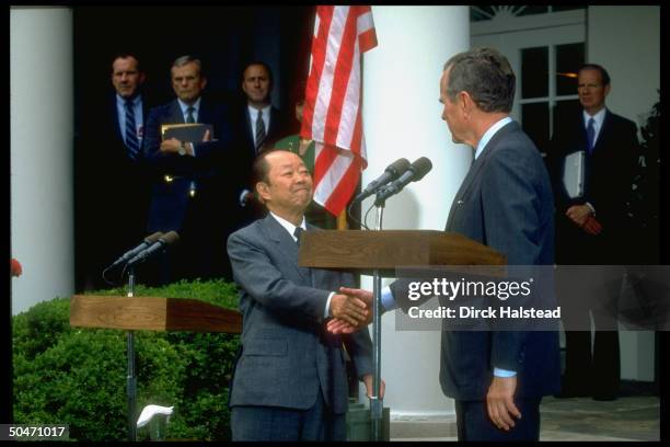 Pres. Bush & Japanese PM Kiichi Miyazawa shaking hands, in WH Rose Garden before going to Camp David, w. Baker , Amb. Armacost & Nick Brady .